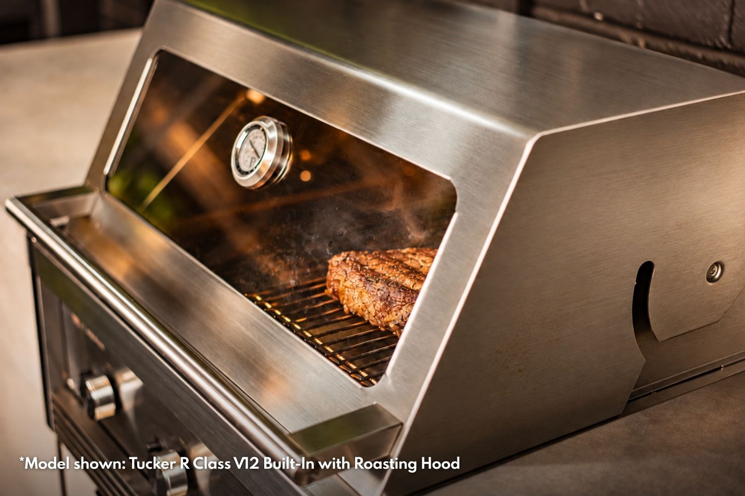 Tucker R Class stainless steel roasting hood with a viewing window, temperature gauge and steak cooking inside